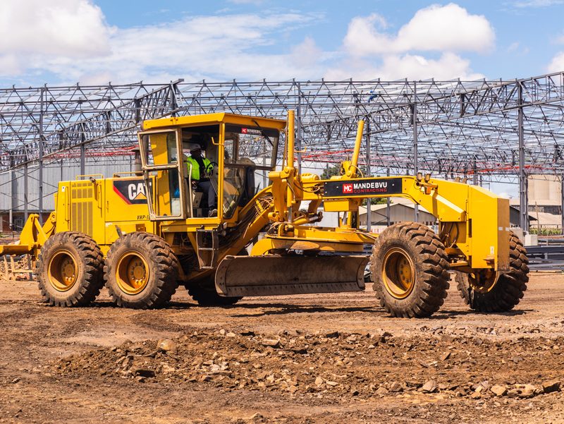 Grader working under the new steel frame